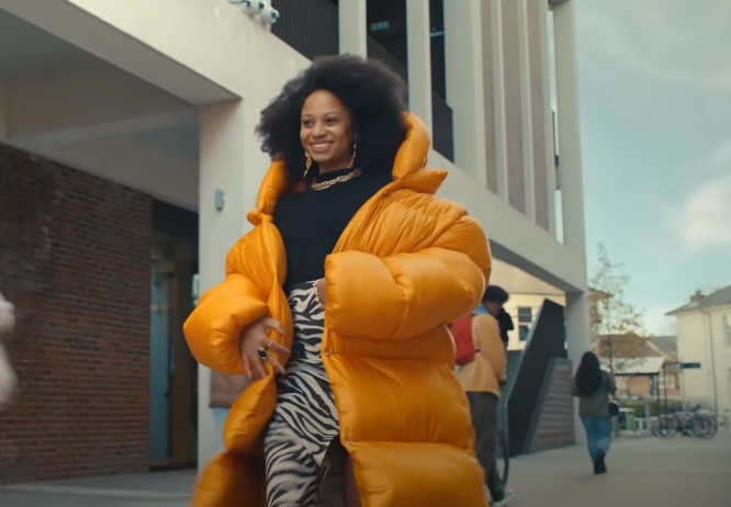 Current Account Switch Service CASS Woman Wearing Orange Puffer Jacket Advert Song